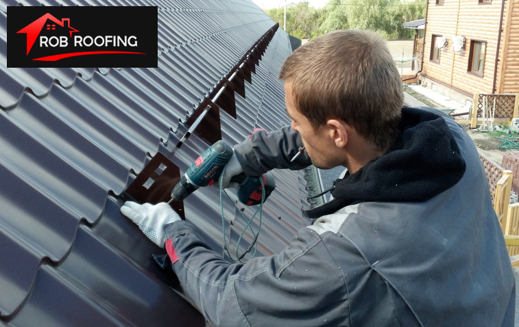 Roofing professional repairing a commercial shingle roof.